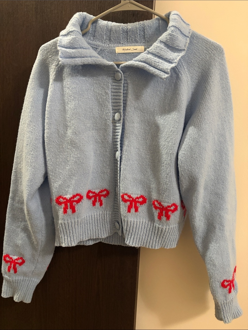 Light Blue Cardigan with Red Bow Accents